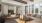 a room with two couches and coffee tables with large windows