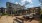 a courtyard with picnic tables and covered seating areas